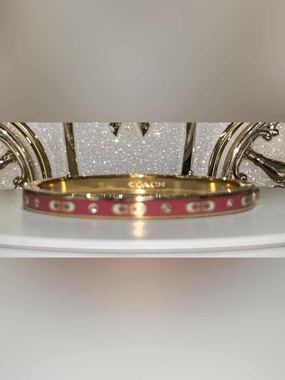 Coach Gold-Tone Hinged
Bangle with Pink Enamel and
Crystal Accents. Good cond.